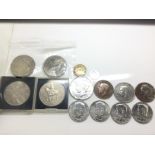 A collection of various coins including dollar coi