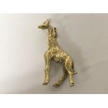 A solid gold pendent in the form of a giraffe unma