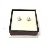 A pair of 18K white gold and pearl studs.