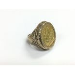 A 1912 half sovereign gold ring, approx 9.6g and a
