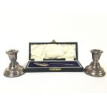 Cased silver spoon and two base hallmarked candle