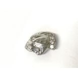 Diamond set lions head, 2.3g. Postage category A