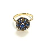 An 18ct gold blue gemstone cluster ring. Size O an