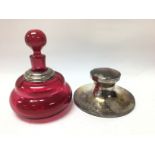 A hallmarked silver capstan inkwell together with a silver mounted cranberry glass perfume