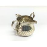 A silver double spout cream jug, London 1894, appr
