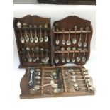 Three wall mounted displays of various collectable spoons. Shipping category B.