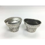 Two silver pepper pots, one lid missing. Shipping