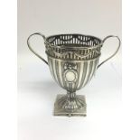 A silver two handled trophy cup with swag decoration above reeded decoration, approx height 13cm,