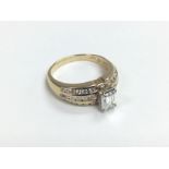 A 14ct gold emerald cut diamond solitaire ring wit