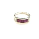 An 18ct white gold ruby and diamond ring. Size N a