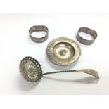 Four silver items comprising a sugar ladle, pin tr