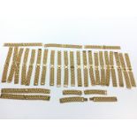 A large collection of gold plated watch straps. Po