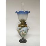 A Victorian porcelain oil lamp the sides decorated with birds with a brass reservoir acid etched
