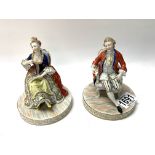 A pair of 20thC Dresden porcelain seated figures,