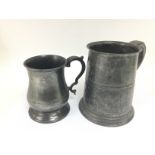 Two 19th Century pewter tankards, largest approx 1