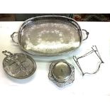 A large silver plate with a box of various silver