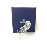 Boxed Swarovski lion standing on a rock, postage c