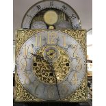 A mahogany long case clock with three train movement striking on eight bells the arched dial with