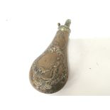 A 19th century brass powder flask decorated with a