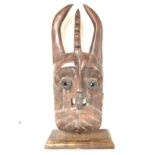 Antique tribal mask with a display stand, approxim