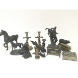 A collection of bronze and metal and other sculptu