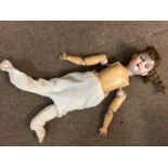 A German bisque headed doll with jointed body. Len