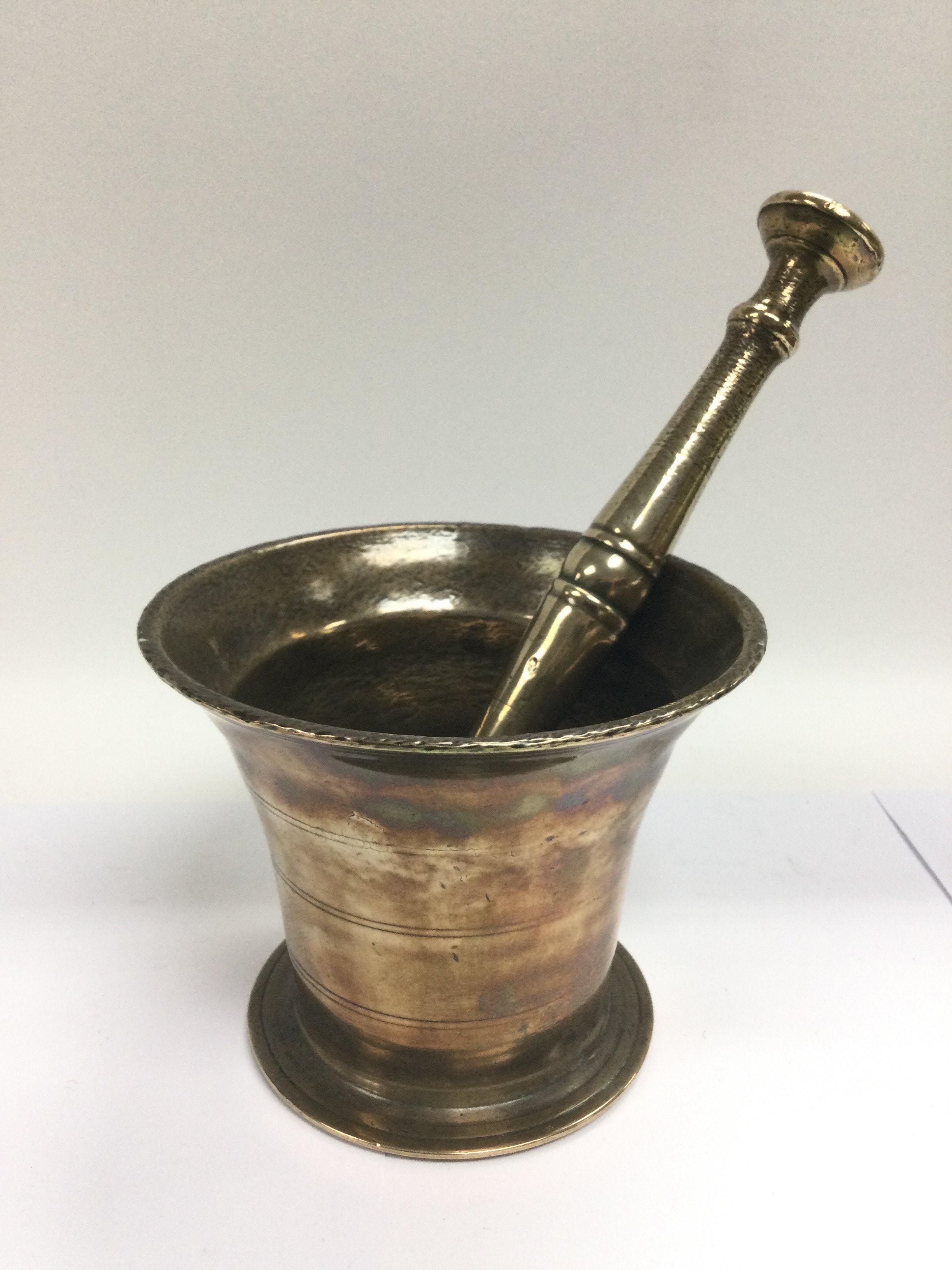 An antique bronzed modtar and pestle and an early