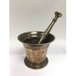 An antique bronzed modtar and pestle and an early