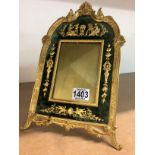 An Empire gilt framed photo frame with raised figures and stylised decoration. In height 32cm