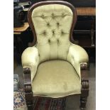 A Victorian arm chair with draylon button back uph