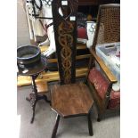 A late Victorian chair with a solid painted back with serpents above a solid seat.