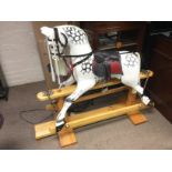 A painted wooden rocking horse. Shipping category D.