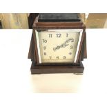 An Art Deco style mantle clock. 19cm wide by 18cm tall. Seen working. Postage C.