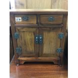 A small 20th century hardwood cabinet with two dra