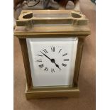 A brass case carriage clock the square dial with Roman numerals.