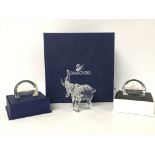 Boxed Swarovski elephant and two paperweights. Pos
