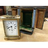 A leather cased brass carriage clock with circular dial and Roman numerals- Benzi Cowes 10.5Cm in