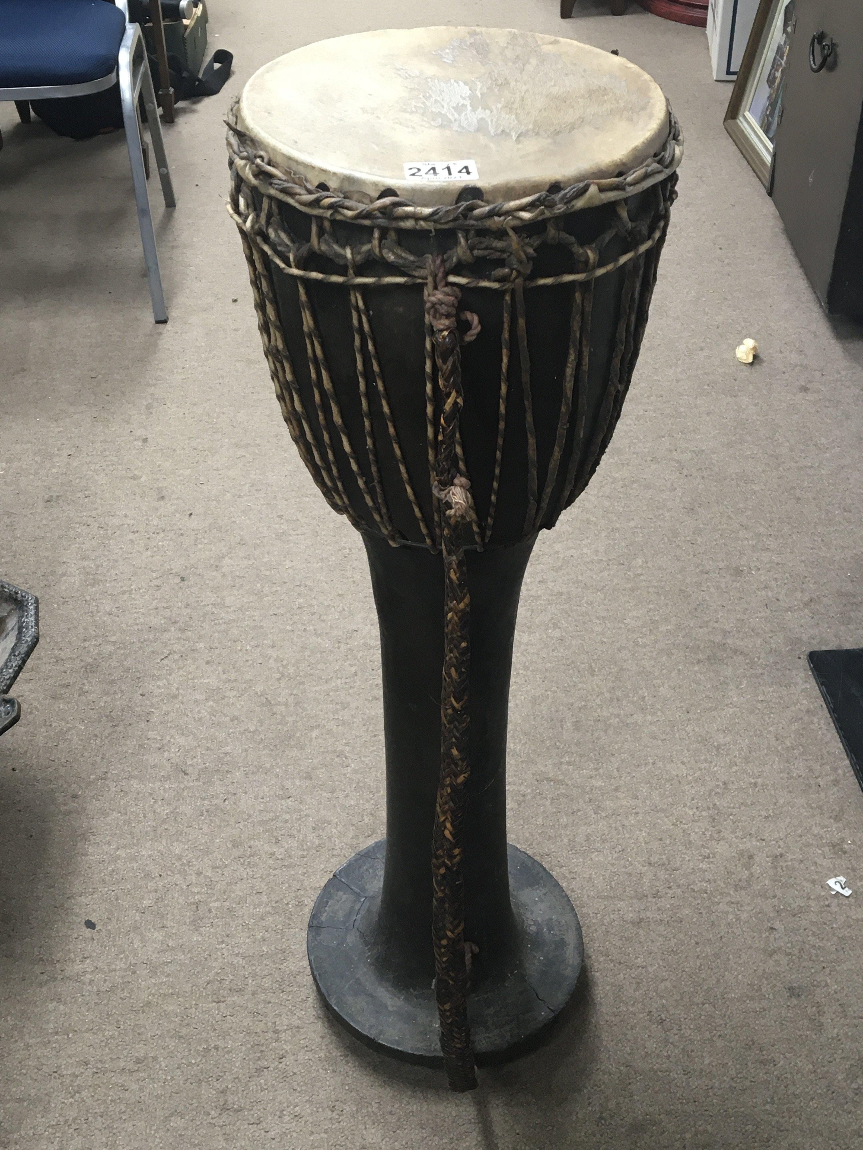 An African tribal free standing drum with a carved