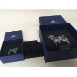 Two Swarovski Crystal cow ornaments in fitted boxes the smaller cow damaged (2)