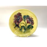 A Moorcroft pottery dish with hibiscus pattern on