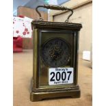 A brass carriage clock having circular dial with A