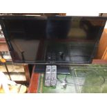 A 32 inch Panasonic flat screen TV with remote con