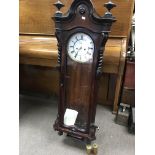 A late 19th century rosewood Vienna style wall clock with two visible brass weights and raised