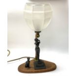 A 1930s lady lamp with an oak base and glass shade