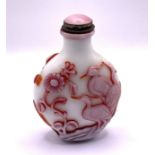 A 2 layered milk glass cameo glass snuff bottle wi