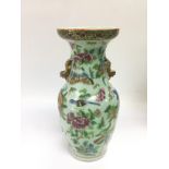 A Canton vase decorated with birds, butterflies an