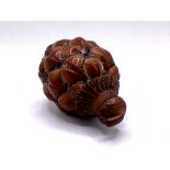 A Chinese pinecone repurposed for use a a snuff bo
