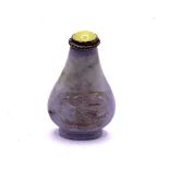 A small carved lavender jade snuff bottle with dra