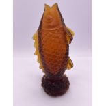 A carved amber glass snuff bottle in the form of a