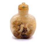 A finely carved hardstone snuff bottle with a carv